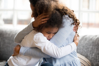 Mother hugs daughter