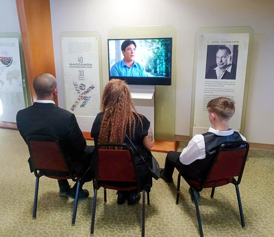 Narconon Arrowhead Community Open House, guests watching Narconon graduate success storries 