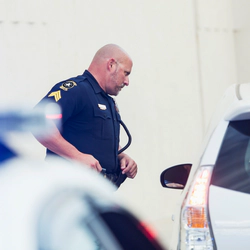 Police officer is checking a car