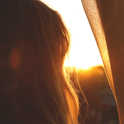 Woman at a window with sunshine