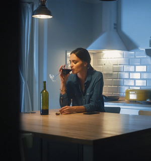 Woman drinking wine at home