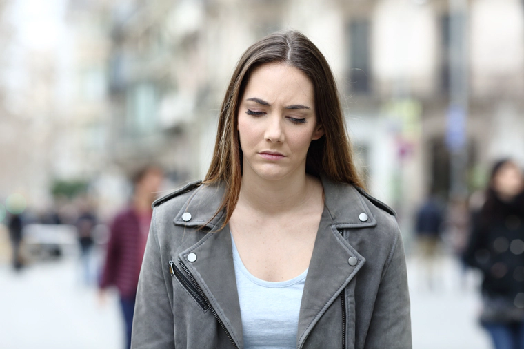 Upset woman is waking, lost look