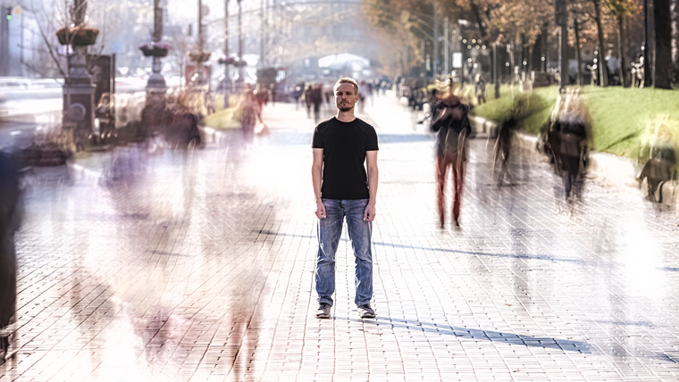 Addict under hallucinogens effect is standing in the crowd.