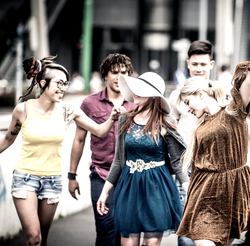 Yong crowd walks on a street