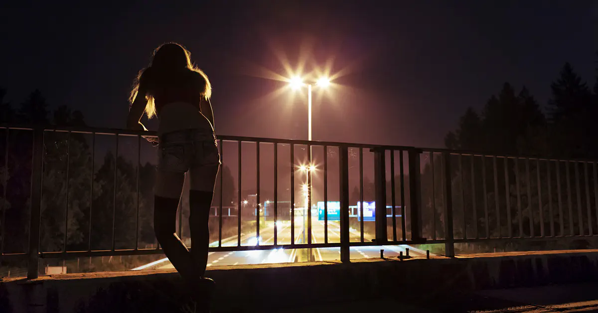 Depressed woman on a highway