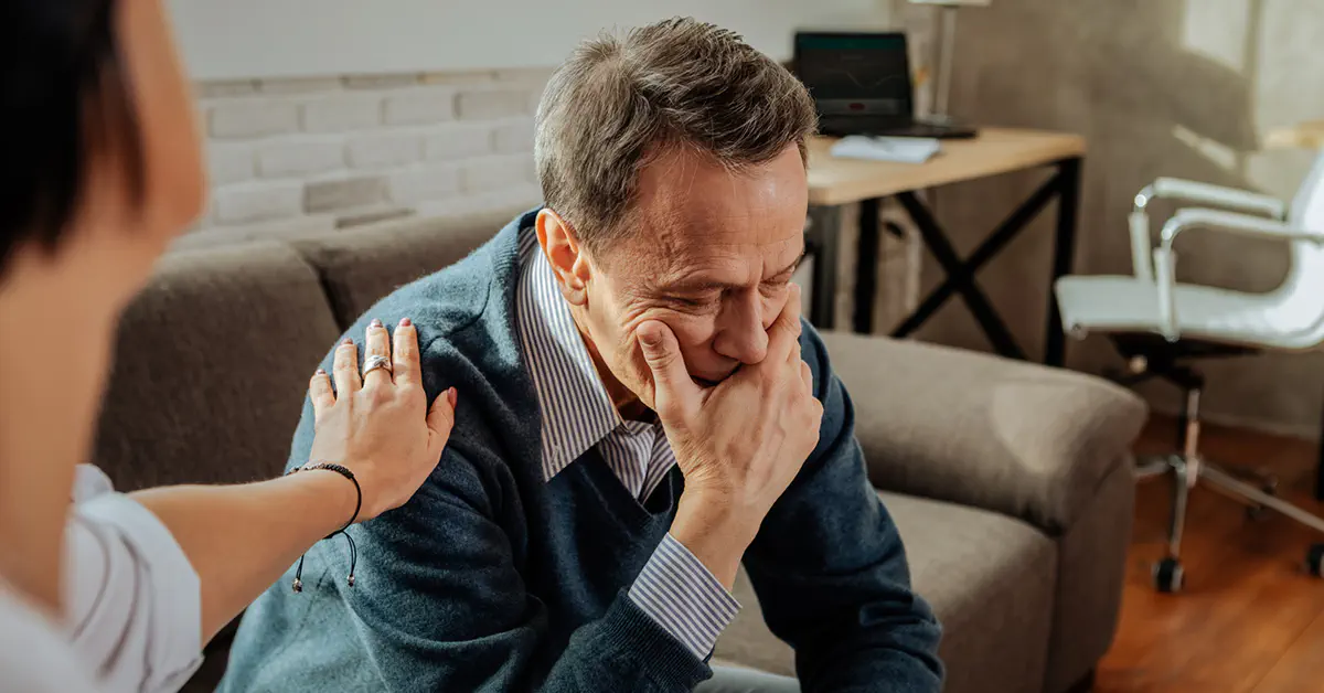 Woman helping husband with alcoholism