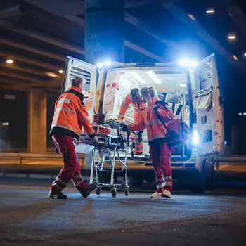 Paramedics loading ambulance