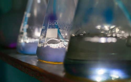 Beakers with bubbling fluid lined up